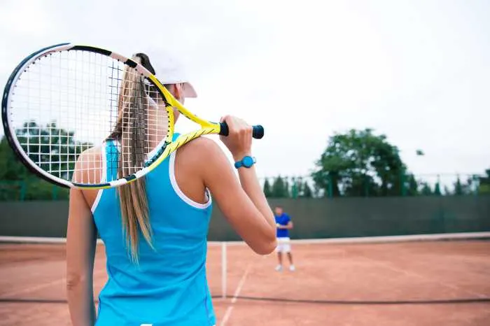 woman playing doubles tennis